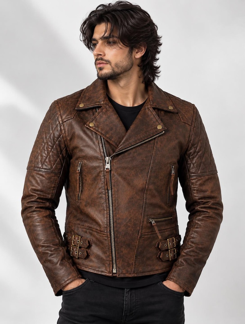 May include: A brown leather motorcycle jacket featuring a distressed finish, an asymmetrical front zip, quilted shoulder panels, notched lapels with metallic snap buttons, two zipped chest pockets, and adjustable side buckles at the waist.