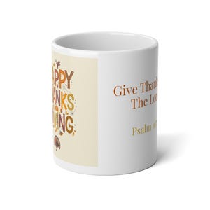 May include: A white ceramic mug featuring a cream-colored panel with the text HAPPY THANKSGIVING in orange, brown, and yellow letters, decorated with small leaves and a turkey. The side displays the text Give Thanks To The Lord Psalm 107:1.
