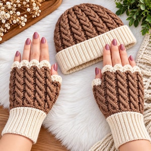 May include: A brown cable-knit beanie hat and a matching pair of fingerless gloves. Both items feature a textured brown cable-knit pattern on the main body, finished with a cream-colored ribbed cuff and a scalloped edge detail at the opening.