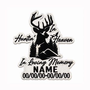 May include: A black and white embroidered patch featuring a deer silhouette, a hunter, and pine trees. The text reads "Huntin' In Heaven", "In Loving Memory", "NAME", and "00/00/00-00/00/00". The design has a white border and a white background.
