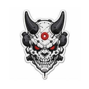 May include: An embroidered patch featuring a stylized robotic demon head with two large black horns, glowing red eyes, and a bright red circular emblem on the forehead. The design incorporates white, gray, and black mechanical details.