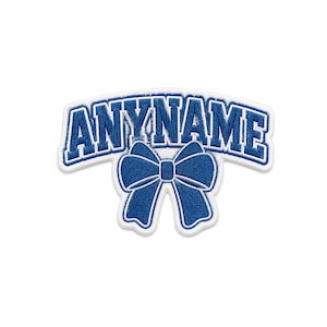 May include: A blue and white embroidered patch featuring the word ANYNAME in a bold, arched varsity-style font. Below the text is a large, detailed blue bow with white outlines, all set against a clean white background for high contrast.