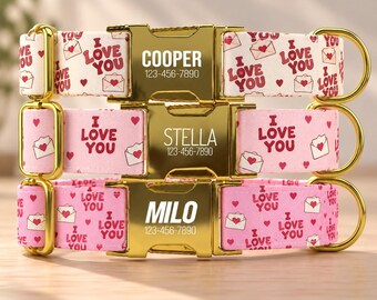 May include: Three pet collars with gold-tone metal buckles engraved with the names COOPER, STELLA, and MILO, each followed by 123-456-7890. The fabric straps feature a repeating pattern of red hearts, envelopes, and the text I LOVE YOU.