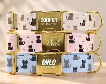 May include: Three pet collars with gold-tone metal buckles. The top collar is cream with brown cats, the middle is pink with black cats wearing bows, and the bottom is light blue with gray cats. Each buckle is engraved with a name and phone number.