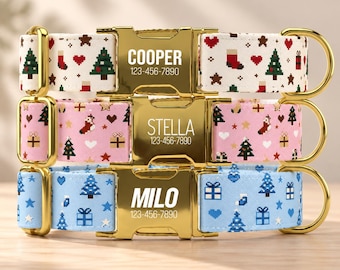 May include: Three pet collars with gold-tone metal buckles engraved with names and phone numbers. The top collar is white with pixelated Christmas trees, stockings, and hearts. The middle is pink with similar motifs. The bottom is light blue.