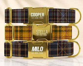 May include: Three dog collars featuring plaid fabric in blue, yellow, and brown tones. Each collar has a gold-tone metal buckle engraved with a name and phone number: COOPER 123-456-7890, STELLA 123-456-7890, and MILO 123-456-7890, with gold hardware.