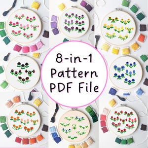以下が含まれることがあります： 木製の刺繍枠に収められた、8つの花のクロスステッチパターン。画像には、カラフルな刺繍糸と「8-in-1 Pattern PDF File」の文字が含まれています。各デザインは異なる花の配置を示しています。