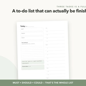 May include: A white daily planner page with the text "THREE TASKS IS A FULL DAY" and "A to-do list that can actually be finished". It features sections for "MUST", "SHOULD", "COULD", a "Brain parking list", "GENTLE CARE", and "One win today".