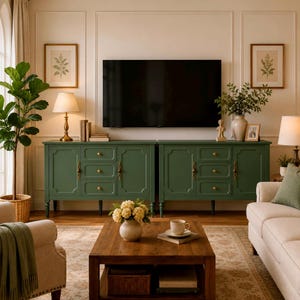 May include: A long, dark green wooden sideboard featuring two cabinets and six central drawers with gold-toned hardware. The piece stands on short, tapered legs and is positioned against a wall beneath a large, flat-screen television.