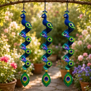 May include: Three hanging crochet peacock ornaments featuring deep blue heads, yellow beaks, and long, spiraling tails in shades of blue, green, and purple. Each tail ends with a large, detailed peacock feather motif and a single yellow bead.