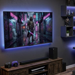 May include: A gaming room featuring a large wall-mounted television displaying a hooded figure with a glowing sword in a neon city, a wooden media console with a game console, a desk with a computer monitor, a gaming chair, and wall shelving.