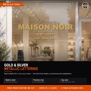 May include: Metallic gold vinyl lettering applied to a glass storefront window. The text reads MAISON NOIR, EST. 2016, and FINE JEWELLERY in a clean, sans-serif font. The lettering has a reflective, smooth finish that appears against the shop interior.