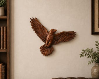 May include: A wall-mounted eagle sculpture crafted from brown wood, depicted in a soaring position with wings fully extended. The carving features detailed feather textures across the wings and tail, with the head turned slightly to the right side.