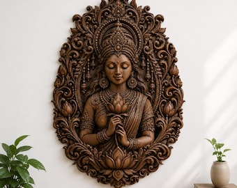 May include: A dark brown oval wall plaque featuring a detailed relief carving of a figure wearing an ornate crown and jewelry, holding a lotus flower. The central figure is surrounded by an intricate frame of swirling floral and leaf patterns.