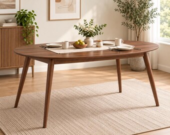 May include: An oval-shaped wooden dining table with a dark brown finish and four tapered legs. The table is set with a light-colored runner, two white ceramic mugs, two white plates, a small wooden bowl containing green fruit, and a vase with flowers.