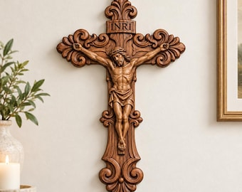 May include: A brown wooden wall crucifix featuring a detailed carved figure of Jesus with a crown of thorns. The cross has ornate scrollwork at the ends and a rectangular plaque at the top with the engraved letters INRI.