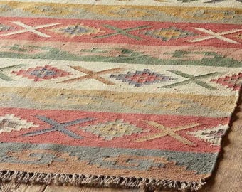 Handgewebter Kelim-Teppich aus Wolle und Jute, in den Farben Altrosa und Salbeigrün, im Dhurrie-Stil.