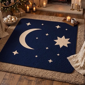 May include: A rectangular navy blue quilted rug featuring a large cream-coloured crescent moon and a prominent eight-pointed star, surrounded by several smaller four-pointed stars scattered across the surface in a celestial pattern.