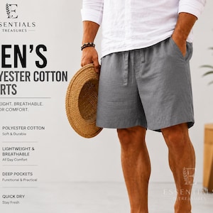 May include: Grey shorts with an elastic waistband and drawstring, featuring text that reads ESSENTIALS D TREASURES, MEN'S POLYESTER COTTON SHORTS, LIGHTWEIGHT, BREATHABLE, MADE FOR COMFORT, POLYESTER COTTON, LIGHTWEIGHT & BREATHABLE, DEEP POCKETS, QUICK DRY.