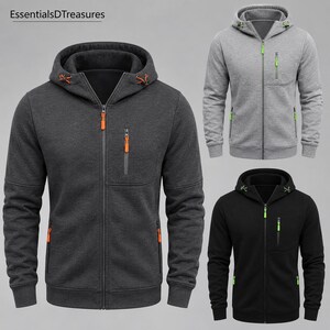 Three zip-up hoodies are displayed: a dark gray one with orange accents, a light gray one with green accents, and a black one with green accents.