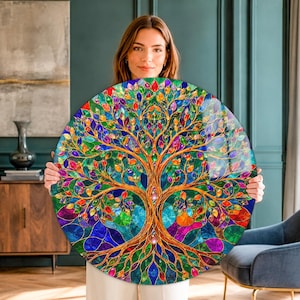 May include: A circular wall art piece featuring a vibrant tree of life design with a stained glass aesthetic. The artwork displays a golden trunk and branches adorned with multicolored leaves in shades of red, blue, green, and purple.