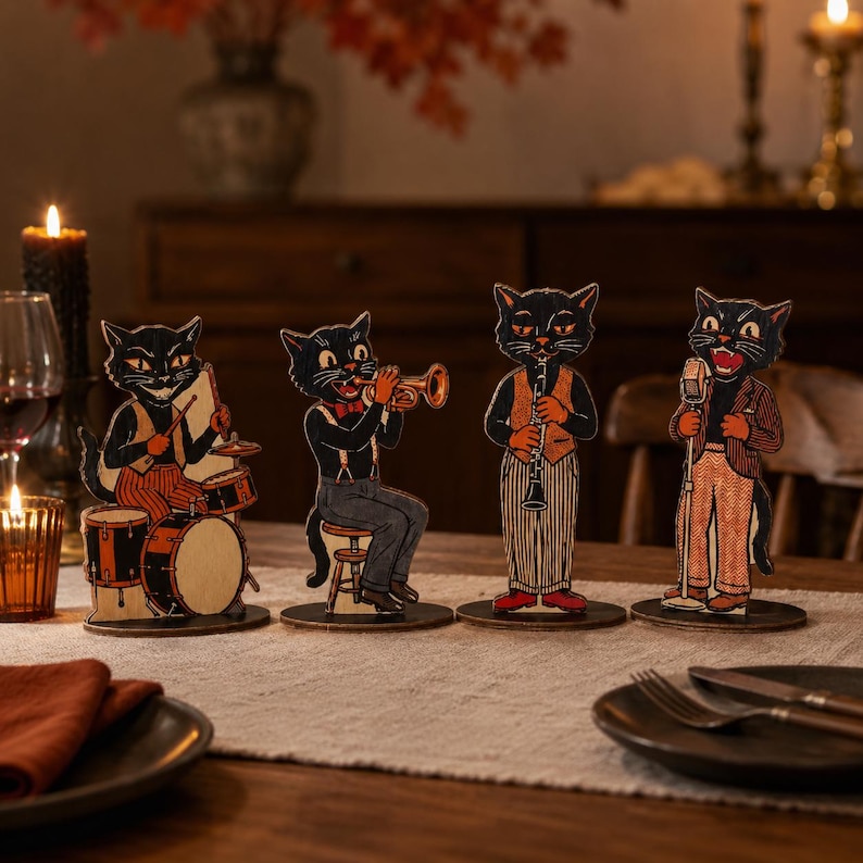 May include: Four freestanding wooden cutouts of black cats dressed in vintage clothing, each playing a different musical instrument including drums, a trumpet, a clarinet, and a microphone, all mounted on circular bases for display.