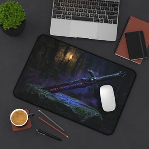May include: A rectangular desk mat featuring a dark fantasy illustration of a sword embedded in a mossy stone. The sword has a black hilt and a blade glowing with purple runes. The background shows a dim, cavernous setting with a faint light source.