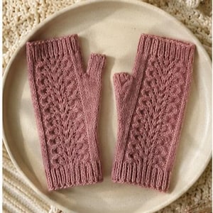 May include: A pair of dusty rose fingerless gloves featuring a vertical lace knit pattern with openwork detailing, ribbed cuffs at the top and bottom, and a dedicated thumb opening, crafted from a soft yarn with a consistent textured finish.