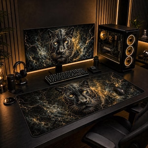 May include: A gaming setup featuring a large desk mat with a black panther graphic against a dark, gold-veined marble background. The same panther design appears on the computer monitor. A black keyboard, mouse, and tower case with gold-lit fans are present.