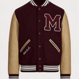 May include: A burgundy varsity jacket with tan leather sleeves, featuring a large white-outlined letter M on the left chest, snap button closure, and striped ribbed trim at the collar, cuffs, and hem. The text Polo R.L. is embroidered in white.