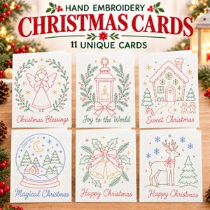 Op de afbeelding: Een set witte wenskaarten met handgeborduurde ontwerpen van een engel, lantaarn, peperkoekhuisje, sneeuwbol, klokken en een rendier. De tekst bevat Christmas Blessings, Joy to the World, Sweet Christmas, Magical Christmas en Happy Christmas.