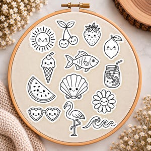 May include: A wooden embroidery hoop containing a collection of black and white stickers featuring cute, smiling faces. The designs include a sun, cherries, strawberry, lemon, ice cream cone, fish, mason jar, watermelon slice, seashell, flower, heart sunglasses, flamingo, and ocean waves.