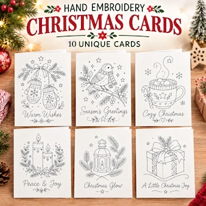 Puede incluir: Un conjunto de diez tarjetas de felicitación blancas con patrones de bordado en línea negra de temas navideños que incluyen manoplas, un pájaro, una taza, velas, un farol y un regalo, con textos como Warm Wishes y Cozy Christmas.