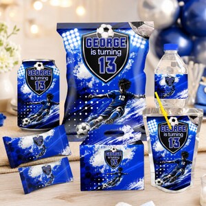 May include: A collection of blue soccer-themed party supplies including a chip bag, water bottle, juice pouch with a yellow straw, two candy bars, and a treat box. Each item features a soccer player graphic and the text George is turning 13.