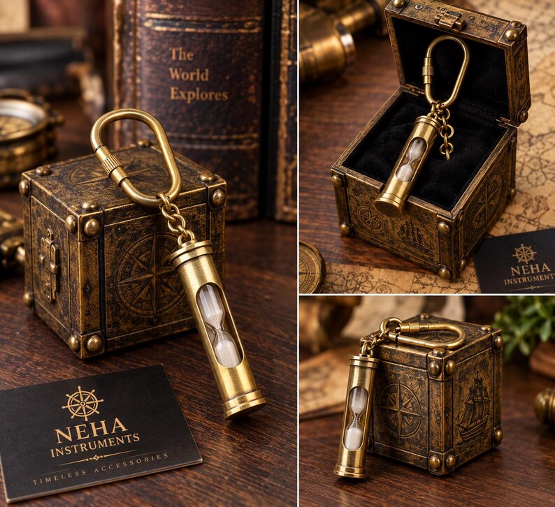 May include: A brass hourglass keyring featuring a cylindrical metal frame with a glass centre containing white sand. The keyring is attached to a brass carabiner and is presented with a square, antique-style box and a black card labelled NEHA INSTRUMENTS.