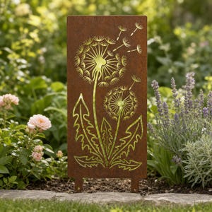 May include: A rectangular garden stake featuring a rusted metal finish with a laser-cut design of two dandelion flowers. The design includes detailed stems, jagged leaves, and floating seeds drifting upward from the flower heads.
