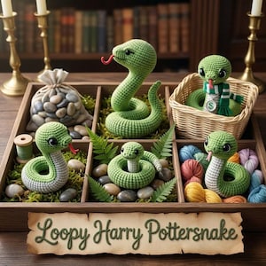 May include: A wooden tray containing five crocheted green snakes with red tongues, smooth stones, green moss, a small wicker basket, and colourful yarn balls. A paper sign in front features the text Loopy Harry Pottersnake in green script.