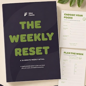 May include: A dark purple planner cover titled The Weekly Reset A 20-Minute Weekly Ritual with green text and the Idea Fauna logo. Two interior pages are visible, titled Choose Your Focus and Plan The Week, featuring lined sections for planning.