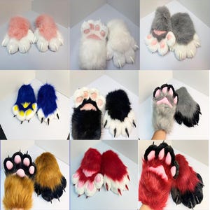 May include: A collection of nine pairs of plush faux fur animal paw gloves in various colour combinations including pink and white, solid white, grey and white, blue and yellow, black and white, grey and black, brown and black, red and white, and red and black, all featuring soft paw pads and pointed claws.
