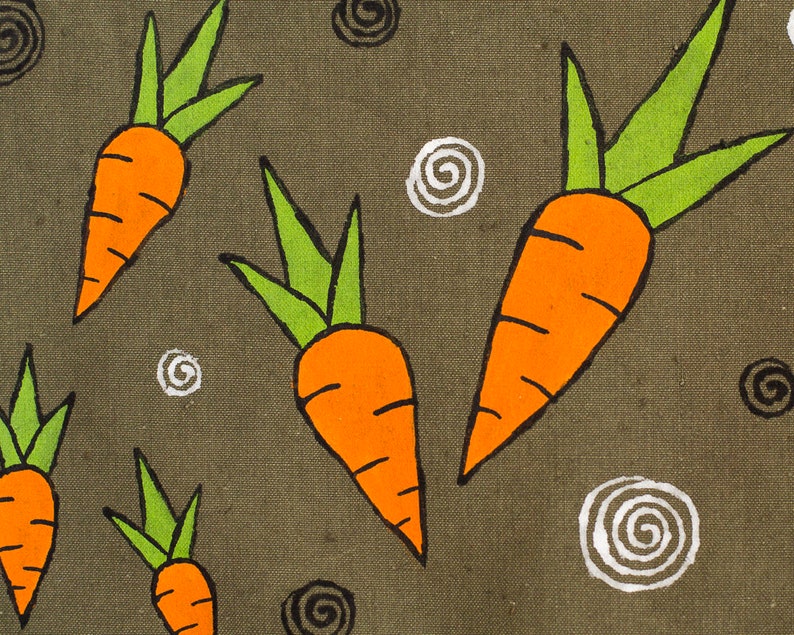 May include: A green canvas fabric with a repeating pattern of orange carrots with green tops and white and black swirl designs.