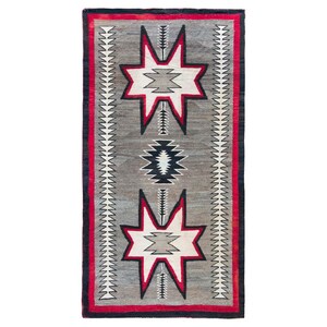 May include: A rectangular woven rug featuring a gray background with two large white star-shaped motifs outlined in black and red. A central black and white diamond pattern sits between the stars, flanked by vertical white sawtooth borders.