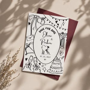 Può includere: Un cartoncino rettangolare bianco Save the Date con illustrazioni a linee nere che includono fedi nuziali, flûte da champagne, una torta e fiori. Il testo recita: Save Our Date, Olivia & Parker, 07. 22. 2021, NY, all'interno di un ovale centrale.