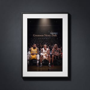May include: A framed wall art print featuring three basketball players sitting on a bench in a stadium. The text Greatness Never Ends is printed above the players. The players wear yellow and white Lakers jerseys and a black Bulls jersey.