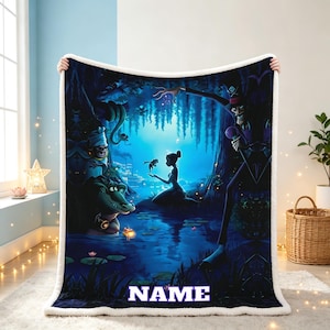 May include: A plush throw blanket featuring a dark, blue-toned swamp scene with a silhouette of a woman holding a frog, a tall figure in a top hat, and an alligator. The word NAME is printed in white block letters at the bottom of the blanket.