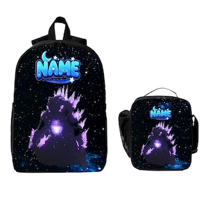 May include: A black backpack and a matching lunch bag, both featuring a cosmic space print with a glowing purple monster silhouette and the word NAME in blue letters at the top, accented by white stars and a crescent moon against a dark background.