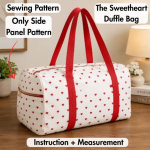 May include: A white duffle bag with a red heart pattern, featuring red fabric handles and a gold zipper. Text on the image reads: Sewing Pattern Only Side Panel Pattern, The Sweetheart Duffle Bag, and Instruction + Measurement.