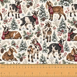 May include: A fabric print featuring goats wearing red patterned scarves amidst snowy pine trees, pinecones, and red berries. A wooden ruler at the bottom shows a scale of 10 inches and 25 cm, confirming the pattern repeat and scale of the design.