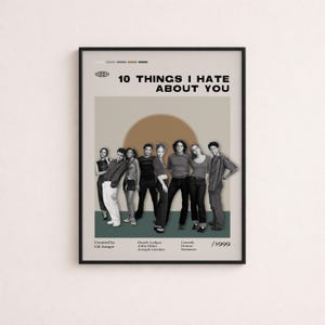 May include: A framed movie poster for 10 Things I Hate About You featuring a black and white cast photo against a beige background with a brown circle. The text includes the title, cast names, director, genre, and the year 1999 in a clean layout.