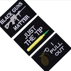 May include: Three black embroidered patches with white text. The first patch says "Black Guns Matter" and features a white silhouette of a rifle. The second patch says "Just The Tip" and features a yellow and green bullet. The third patch says "To Pull Out" and features a green grenade.