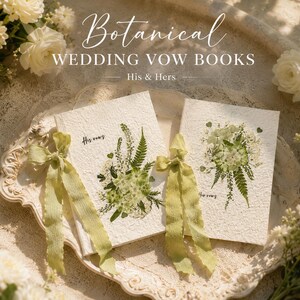 May include: Two off-white textured vow books featuring pressed green botanical arrangements and light green ribbon ties. The left book is inscribed with "His vows" and the right book with "Her vows". The text "Botanical WEDDING VOW BOOKS His & Hers" appears above.